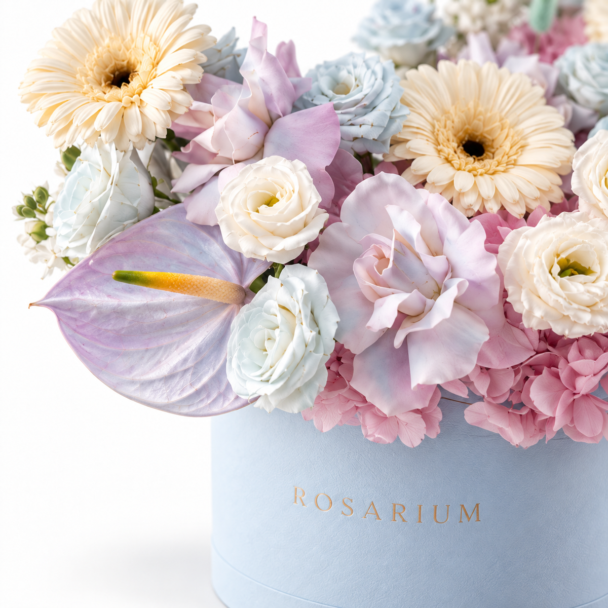 Azure Drift floral detail, blue and blush hydrangea, white roses, cream gerberas, white lisianthus and lilac anthuriums in a powder blue Rosarium box
