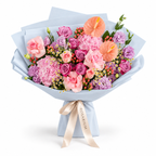 Blush After Dark, deep-purple and pink roses, pink hydrangea, anthuriums and purple lisianthus in blue wrapping