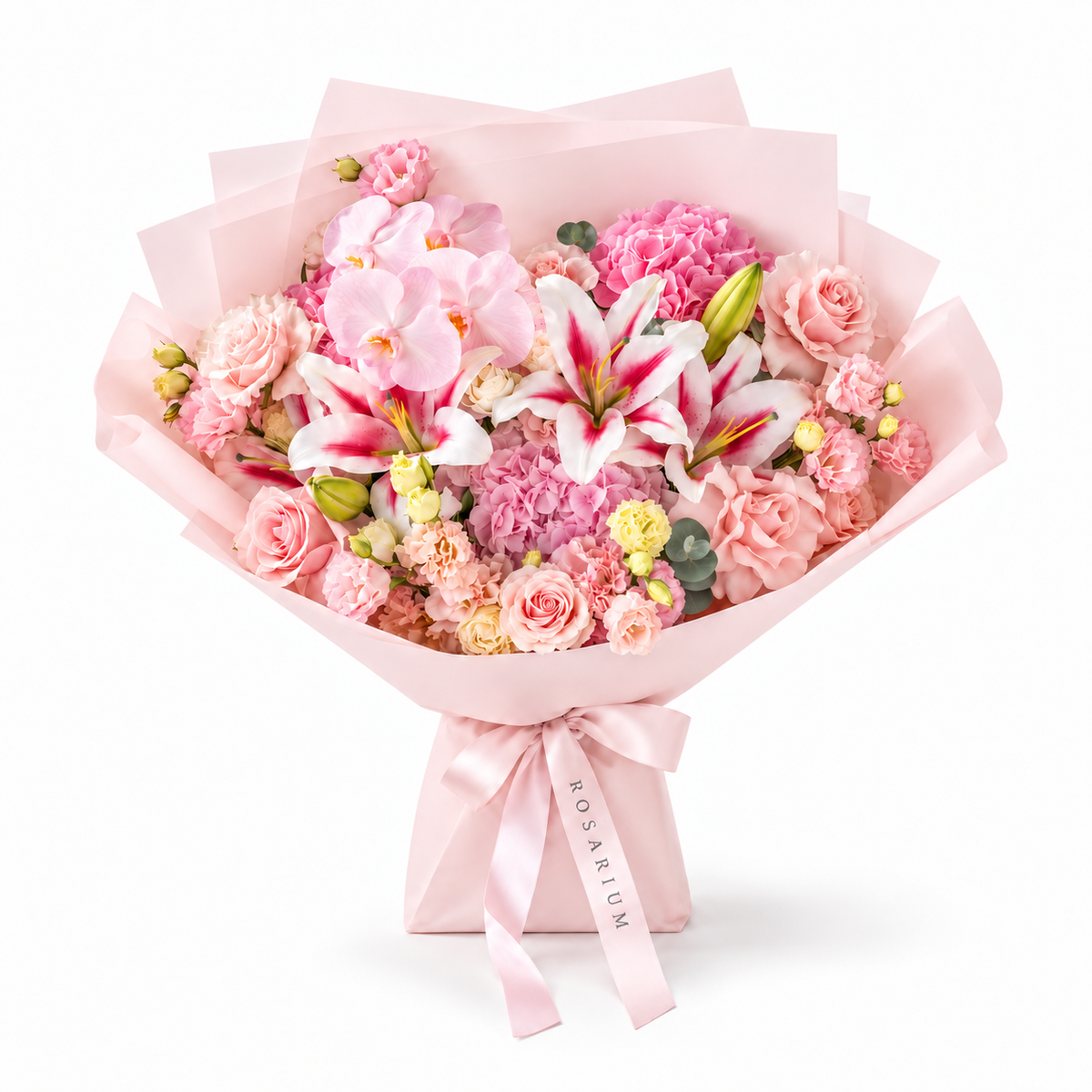 Blush Spectacle, pink orchids, pink and white lilies, blush roses, hydrangea and carnations in light pink wrapping