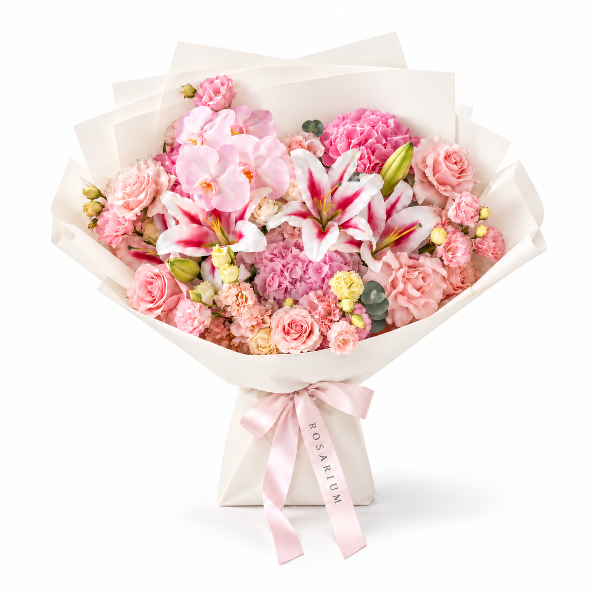Blush Spectacle, pink orchids, pink and white lilies, blush roses, hydrangea and carnations in off-white wrapping