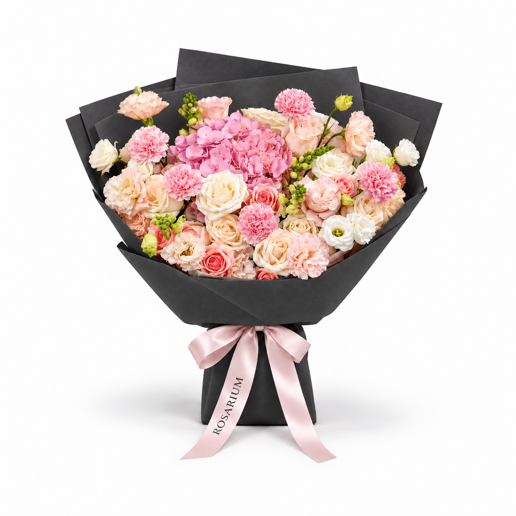 Coral Spark, cream and coral roses, pink hydrangea, carnations and cream lisianthus in black wrapping