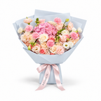 Coral Spark, cream and coral roses, pink hydrangea, carnations and cream lisianthus in blue wrapping