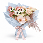 Cream with an Edge, cream and blush roses, white anemones and cream orchids in blue wrapping