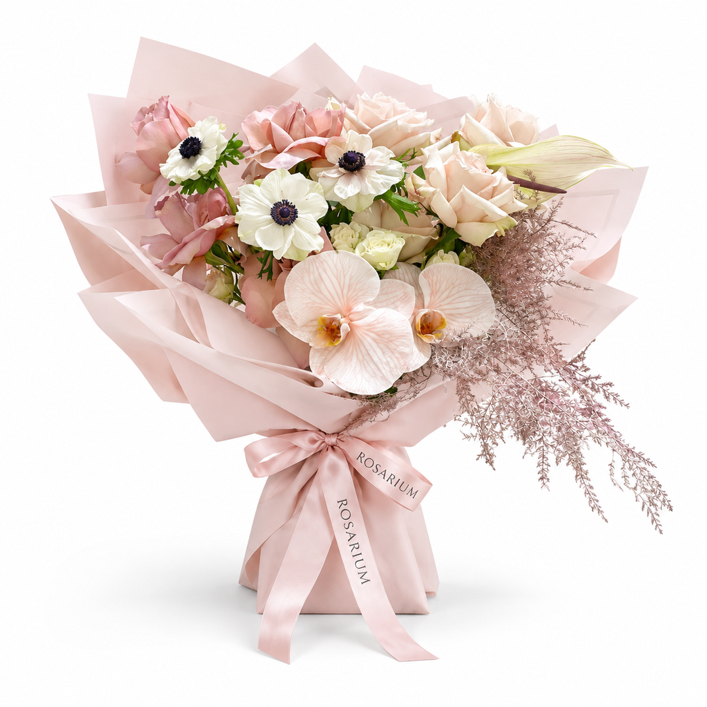 Cream with an Edge, cream and blush roses, white anemones and cream orchids in light pink wrapping