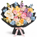 Colour Daydream, yellow roses, pink ranunculus, white anthuriums and lavender stock in black wrapping