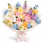 Colour Daydream, yellow roses, pink ranunculus, white anthuriums and lavender stock in off-white wrapping