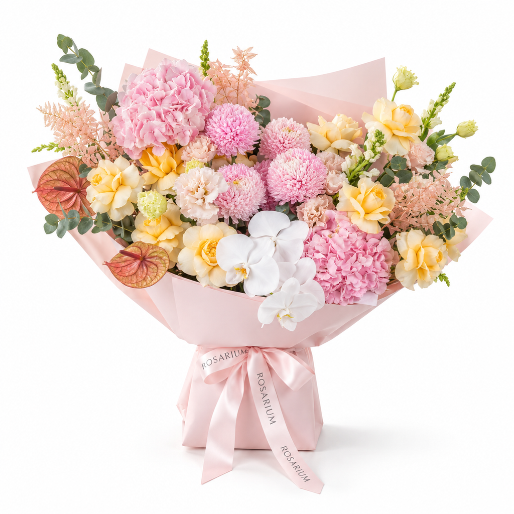 Marina in Colour, yellow roses, pink chrysanthemums, white orchids, hydrangea and lisianthus in light pink wrapping
