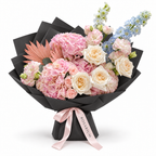 Blue in the Blush, pink hydrangea, blush roses and pale-blue delphinium in black wrapping