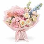 Blue in the Blush, pink hydrangea, blush roses and pale-blue delphinium in light pink wrapping