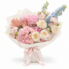 Blue in the Blush, pink hydrangea, blush roses and pale-blue delphinium in off-white wrapping