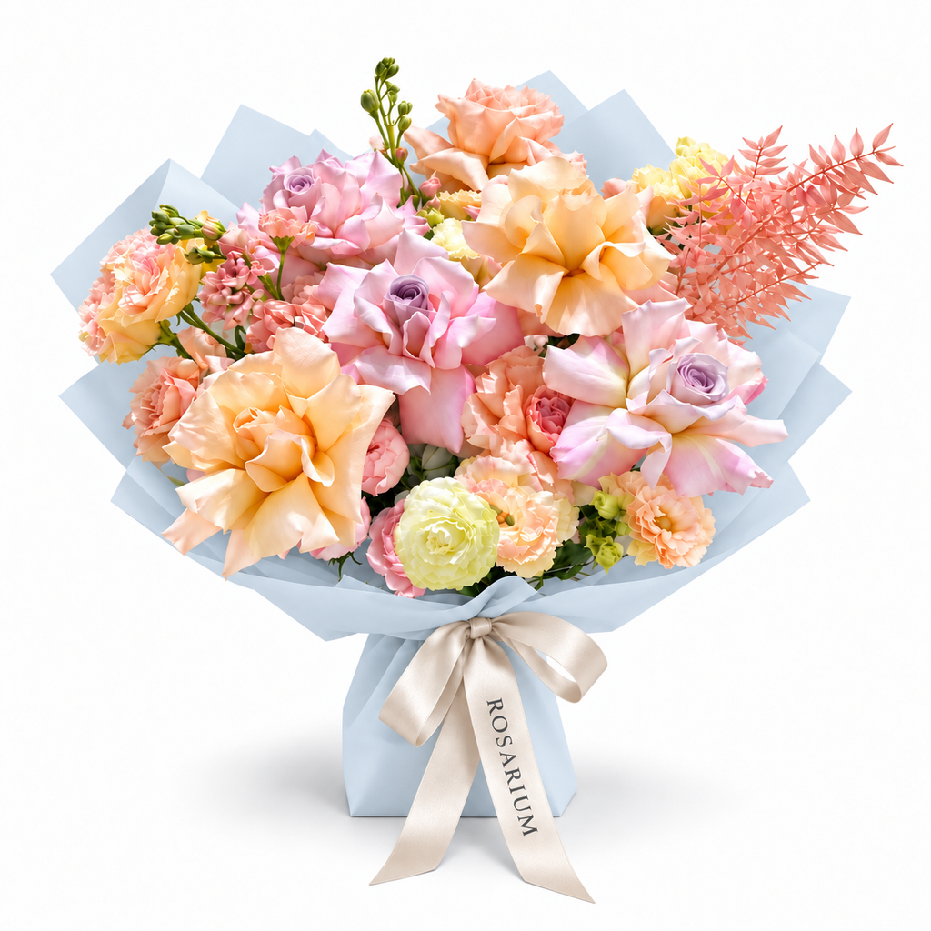 Peach Blush Club, pink and peach roses, spray roses, white stock and lisianthus in blue wrapping