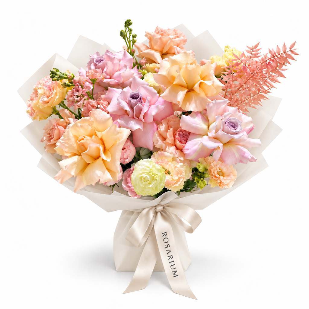 Peach Blush Club, pink and peach roses, spray roses, white stock and lisianthus in off-white wrapping