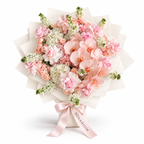 Pink Lemonade Deluxe, light-pink roses, white orchids and white and blush hydrangea in off-white wrapping