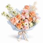 Peach in Bloom, peach roses, blush ranunculus, white stock and cream blooms in blue wrapping