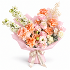 Peach in Bloom, peach roses, blush ranunculus, white stock and cream blooms in light pink wrapping