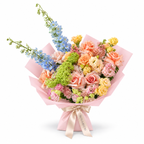 Spring with a Twist, blue delphinium, peach roses, yellow spray roses and blush carnations in light pink wrapping
