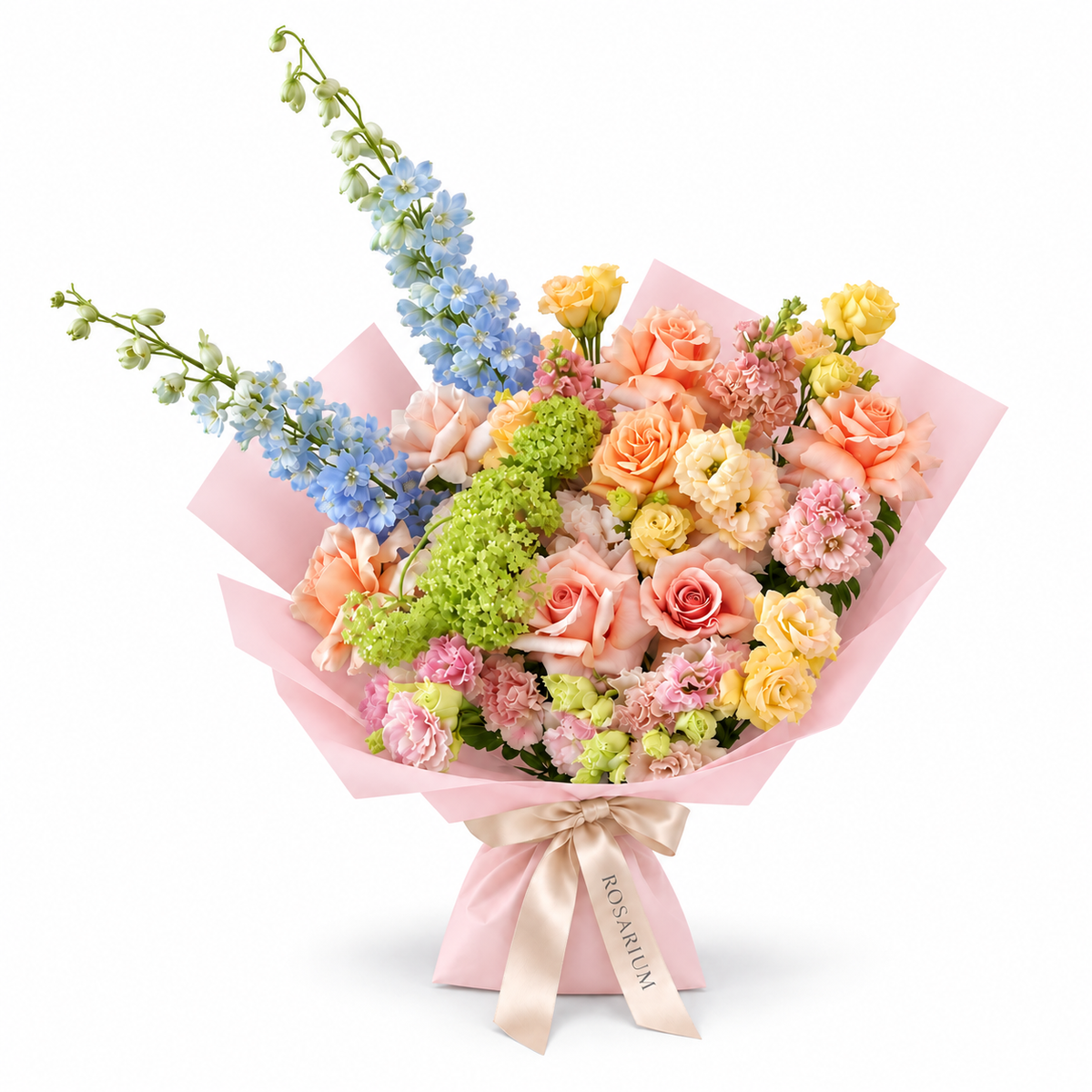Spring with a Twist, blue delphinium, peach roses, yellow spray roses and blush carnations in light pink wrapping