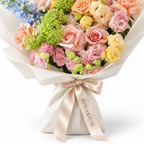 Spring with a Twist, blue delphinium, peach roses, yellow spray roses and blush carnations, packaging detail