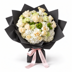 Buttercream Spring, cream and pale-yellow roses with white hydrangea in black wrapping