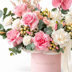 Blush, Interrupted floral detail, pink anthuriums, white roses, peach spray roses and white carnations in a light pink Rosarium box