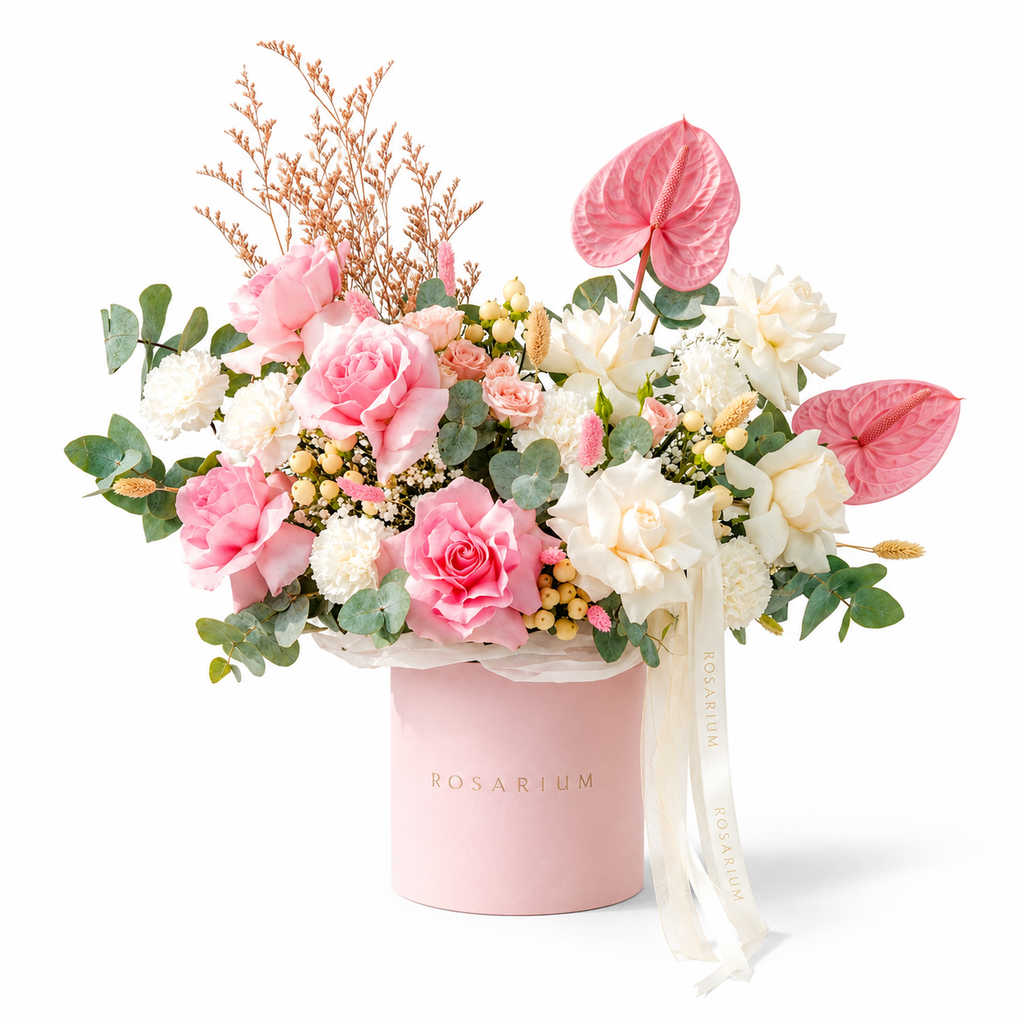 Blush, Interrupted main view, pink anthuriums, white roses, peach spray roses and white carnations in a light pink Rosarium box