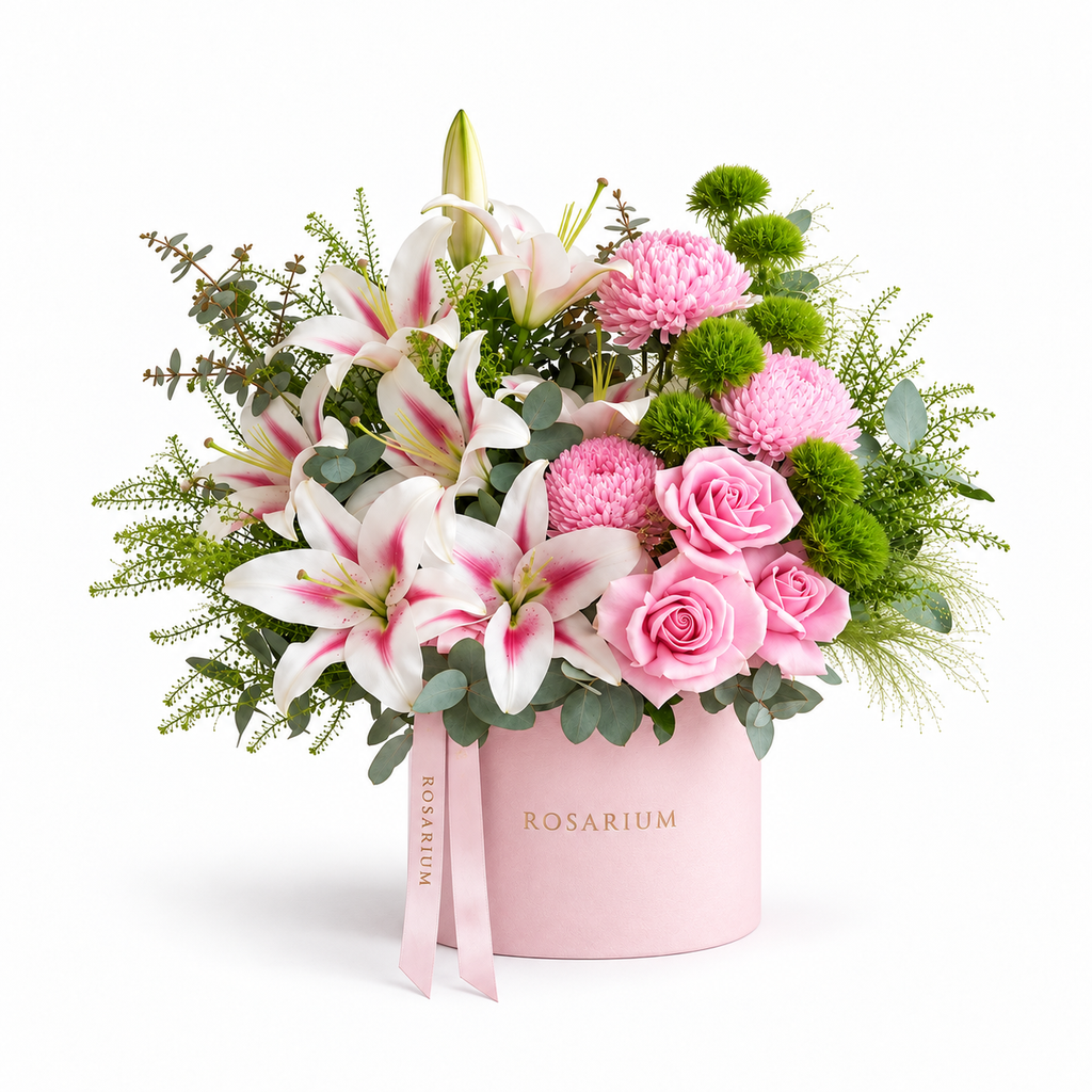 Lily Meadow main view, pink lilies, blush roses, pink chrysanthemums and green carnations in a light pink Rosarium box
