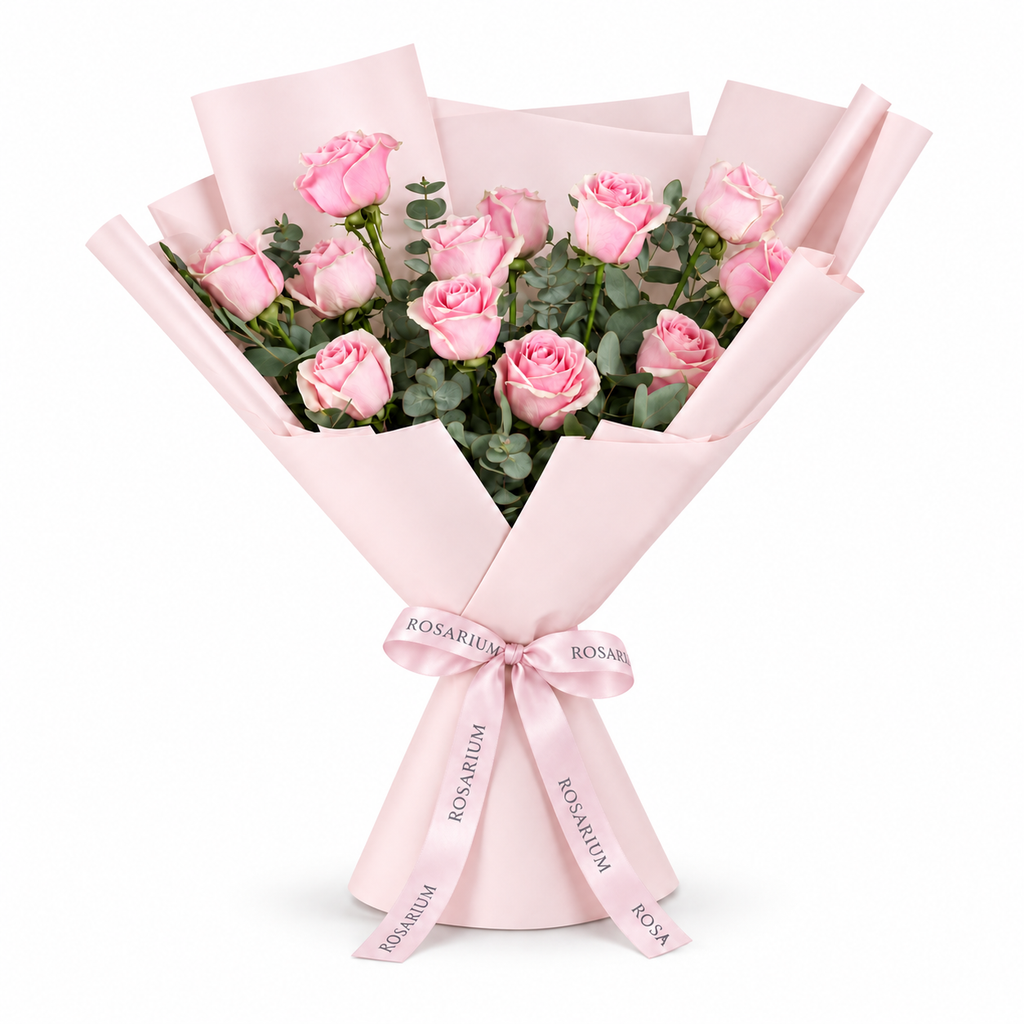 12 pink roses in light pink wrapping with a Rosarium ribbon