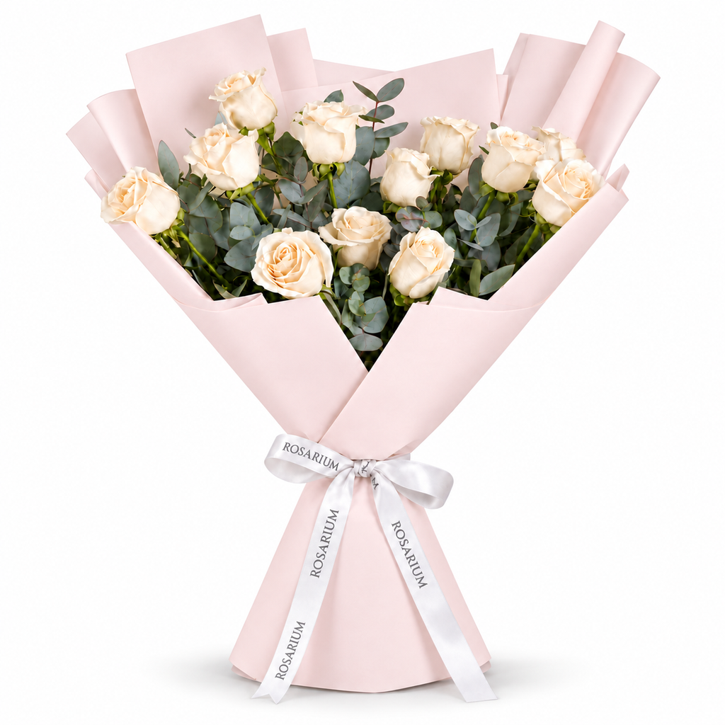12 white roses in light pink wrapping with a Rosarium ribbon