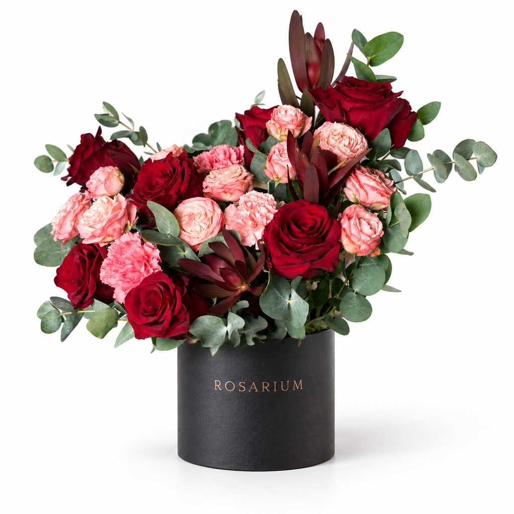 A Blush Love Note: red and pink roses with burgundy accents and eucalyptus in a black Rosarium flower box