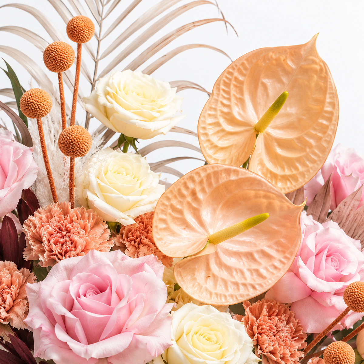 Blush, Interrupted: close-up of peach anthuriums, pink roses and small orange accents
