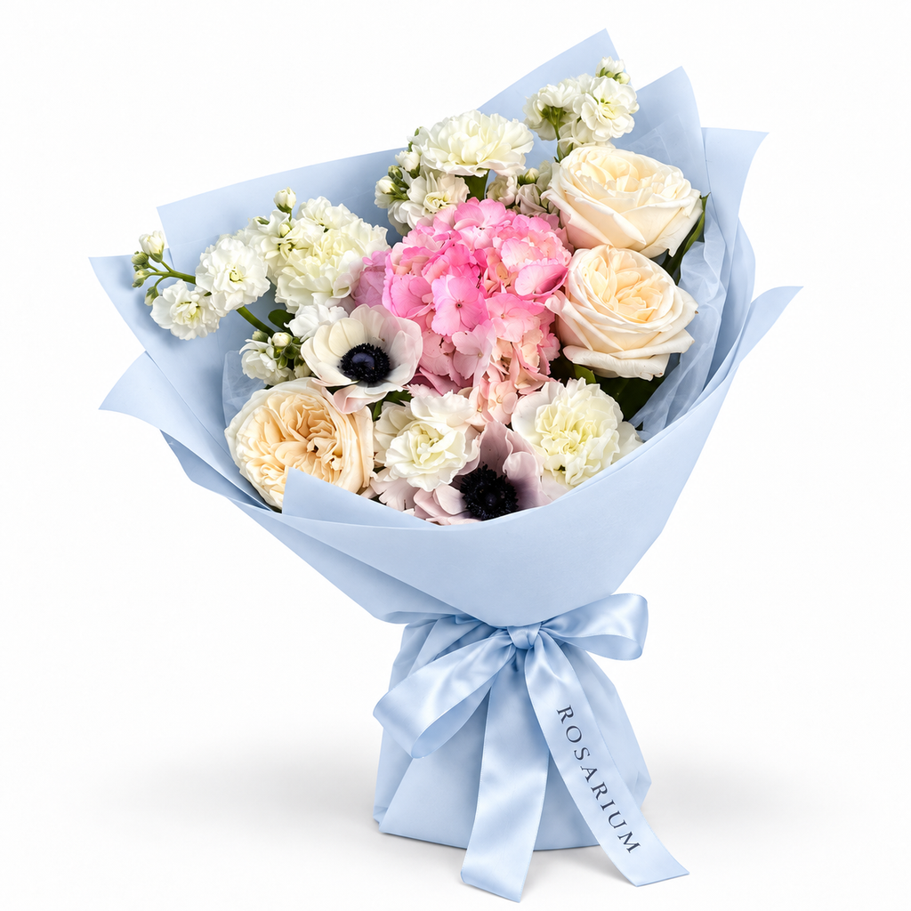 Cream with an Edge: cream roses, white anemones and pink hydrangea in blue wrapping