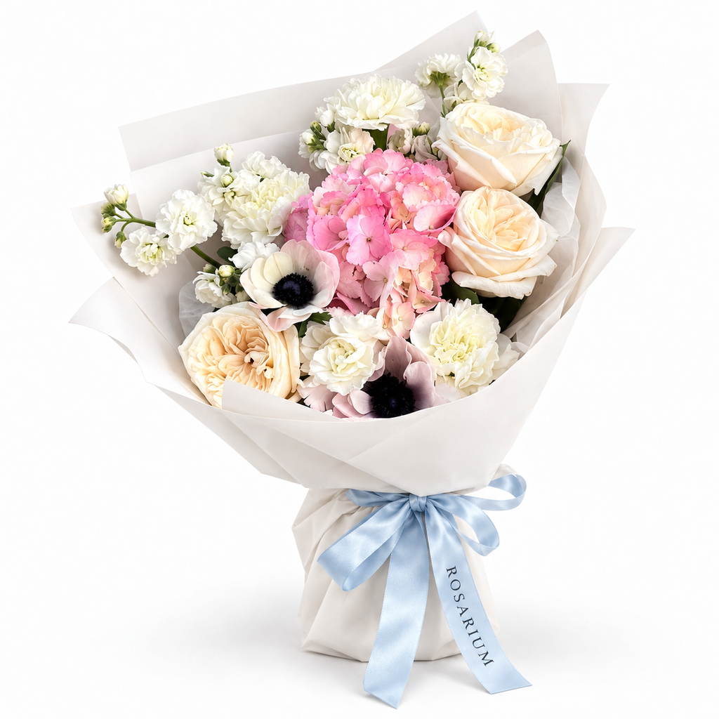 Cream with an Edge: cream roses, white anemones and pink hydrangea in off-white wrapping