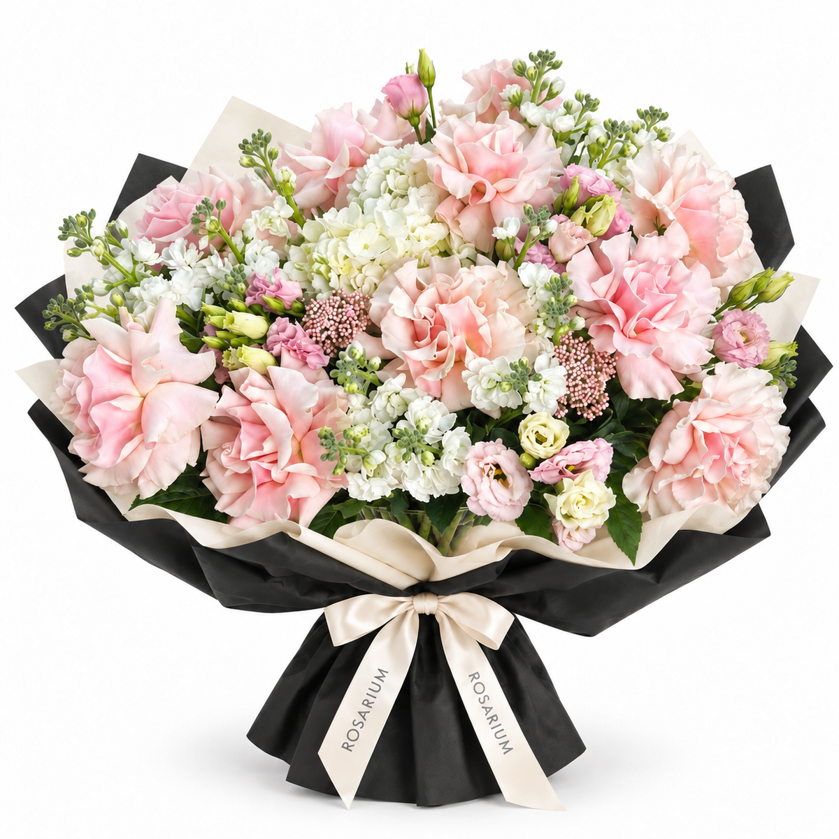 A Soft Romance — Open blush roses, white stock and pale lisianthus with delicate pink filler flowers and green buds in black-and-ivory wrapping