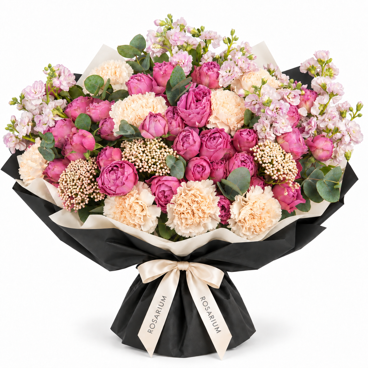 Berry Ruffle — Berry-pink roses, cream carnations and pale lilac stock, softened with delicate filler flowers and eucalyptus in Rosarium’s black-and-ivory wrapping