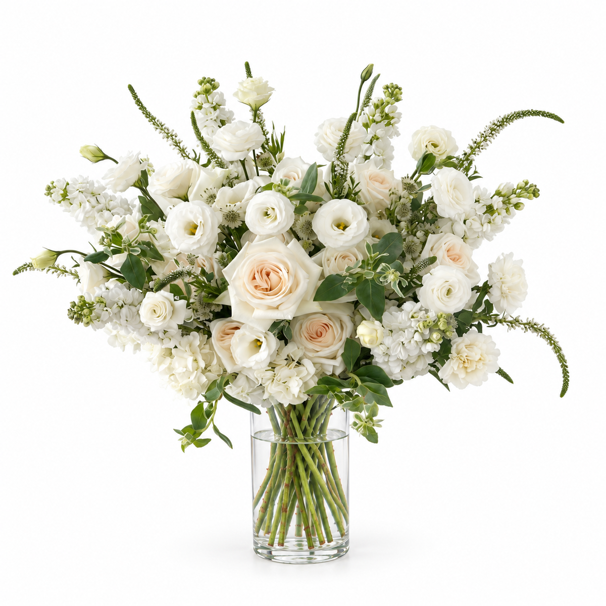 Ivory Daybreak in a Vase — Ivory roses, white lisianthus and stock with slender veronica, delicate astrantia and fresh greenery, arranged in a clear glass vase.