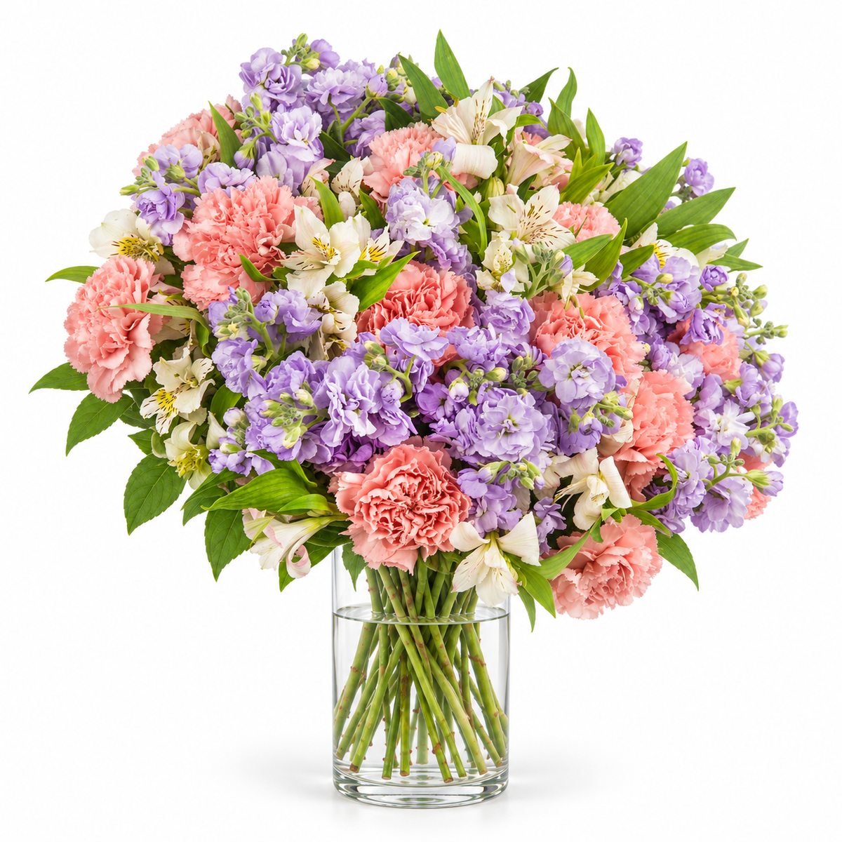 Lilac Confetti in a Vase — Lilac stock, coral-pink carnations and cream alstroemeria with fresh green foliage, arranged in a clear glass vase.