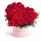 Heart in Red: red roses arranged as a heart in a light pink Rosarium flower box