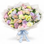 Marina in Colour: pastel roses, white orchids and small yellow flowers in off-white wrapping