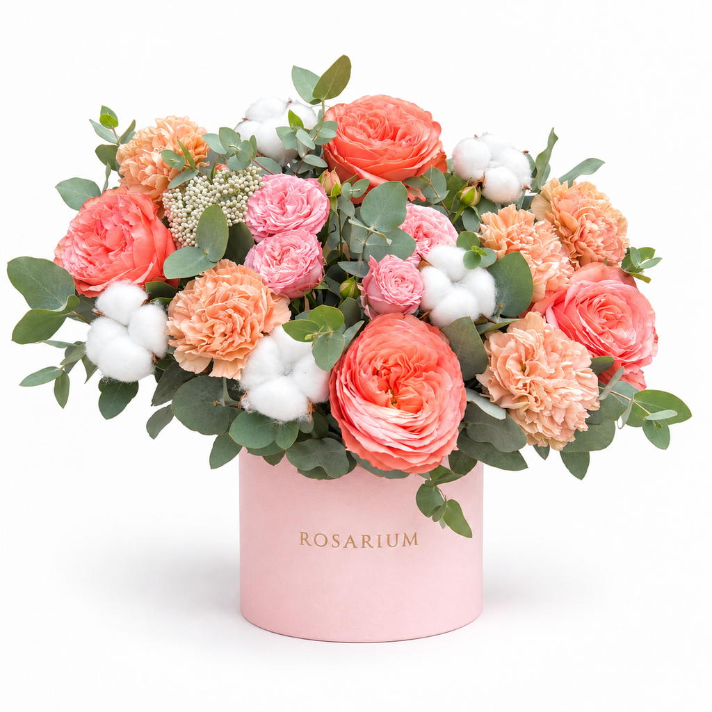 Peachy Magic: coral roses, peach carnations, cotton and eucalyptus in a light pink Rosarium flower box