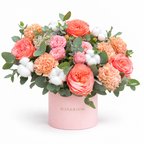 Peachy Magic: coral roses, peach carnations, cotton and eucalyptus in a light pink Rosarium flower box
