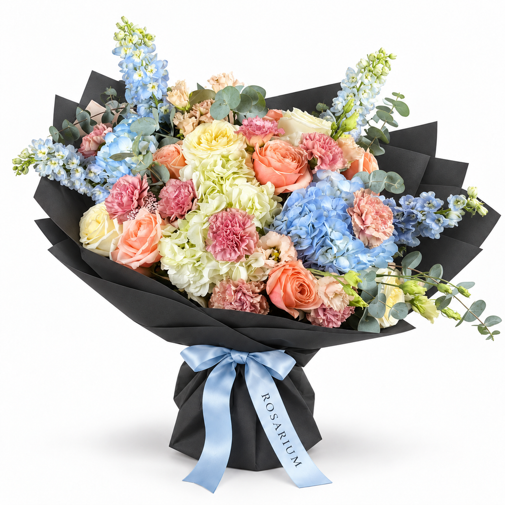 Spring with a Twist: blue and white hydrangea, peach roses and pink carnations in black wrapping