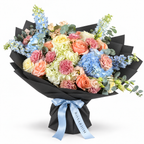 Spring with a Twist: blue and white hydrangea, peach roses and pink carnations in black wrapping