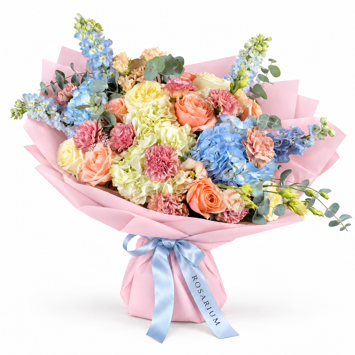Spring with a Twist: blue and white hydrangea, peach roses and pink carnations in light pink wrapping