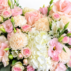Sugar-Hearted: close-up of pink roses and cream flowers arranged as a heart