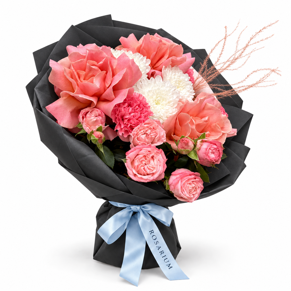 Tuscan Afterglow: coral and pink roses, pink carnations and white flowers in black wrapping