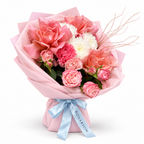 Tuscan Afterglow: coral and pink roses, pink carnations and white flowers in light pink wrapping