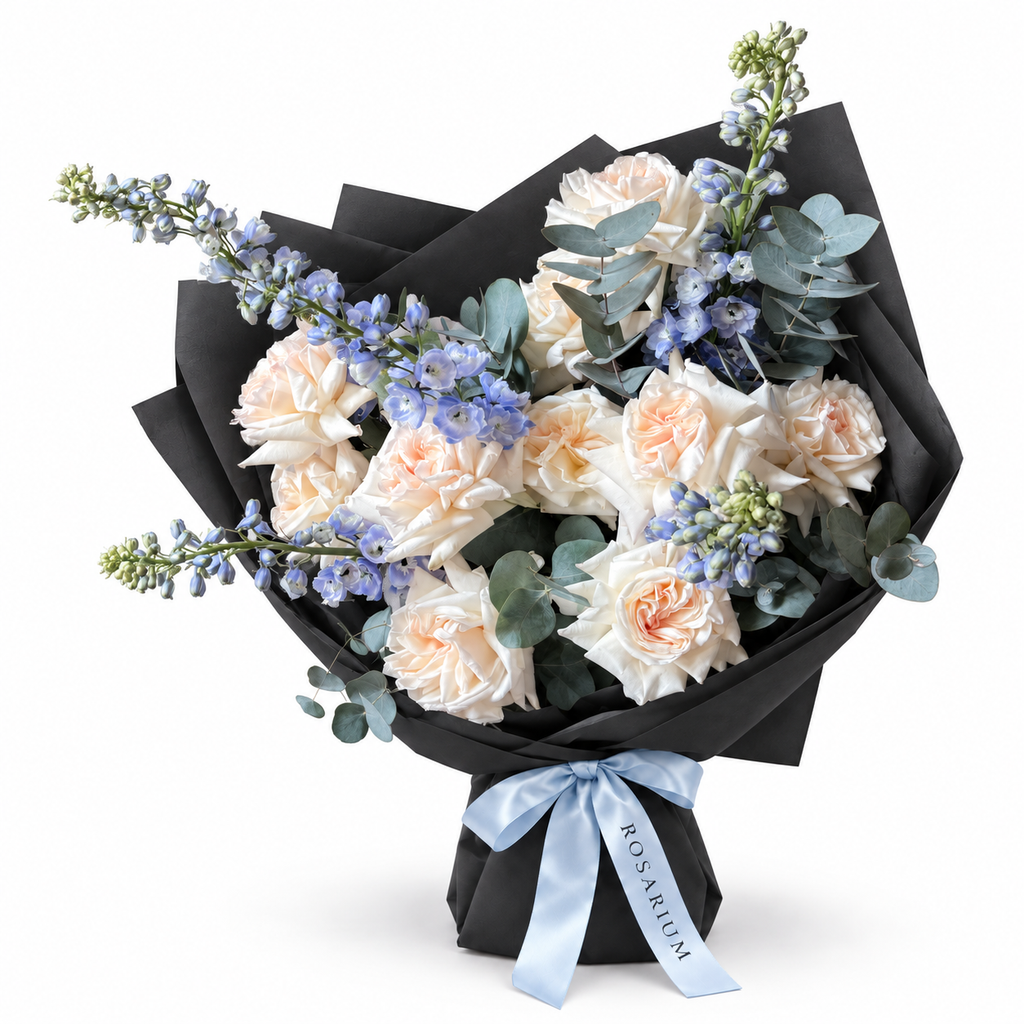 White on Ice: cream roses, blue delphinium and eucalyptus in black wrapping