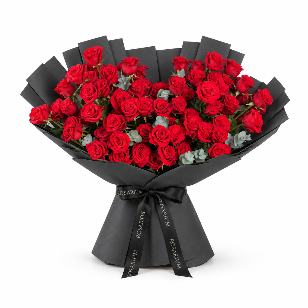 Red roses and eucalyptus in black wrapping with a Rosarium ribbon