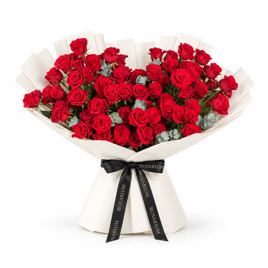 Red roses and eucalyptus in off-white wrapping with a Rosarium ribbon