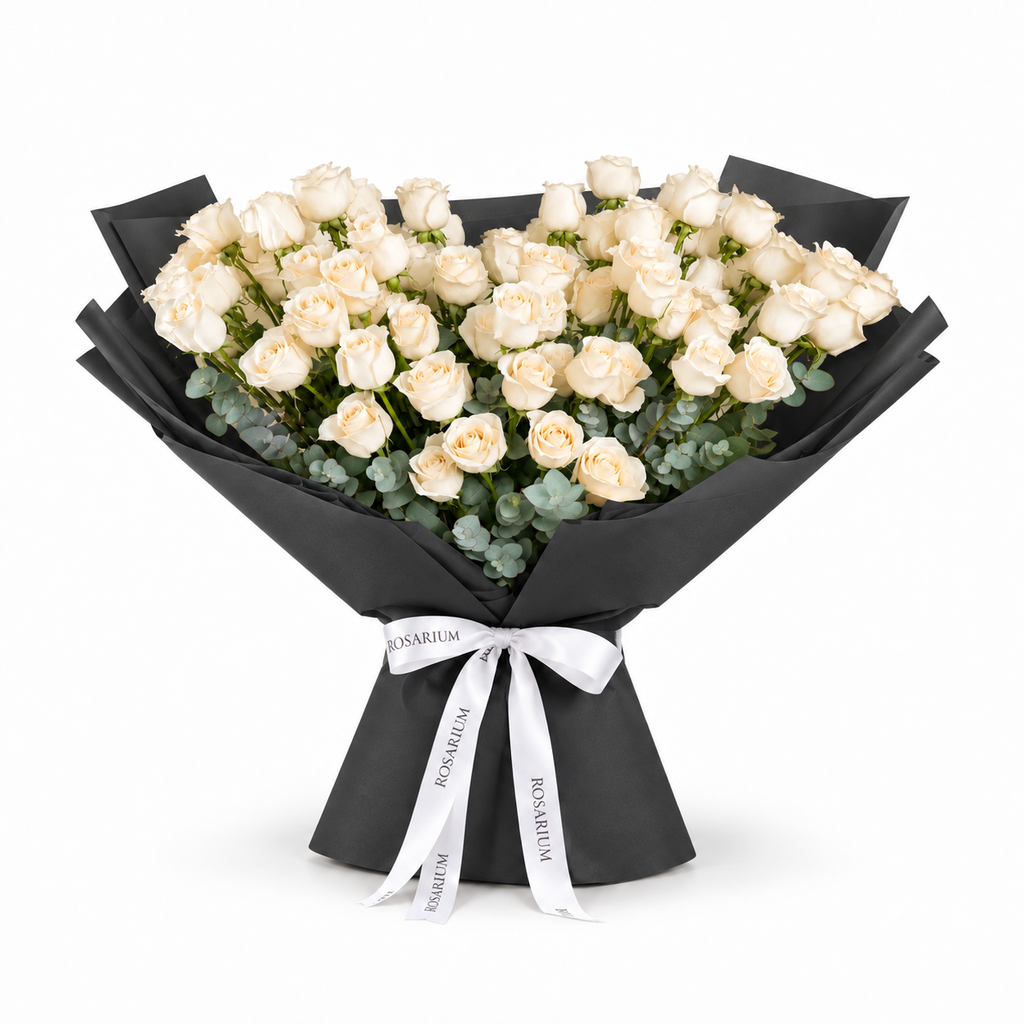 White roses and eucalyptus in black wrapping with a Rosarium ribbon